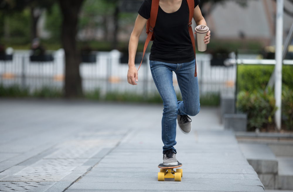 A skateboarder with a holder for hot drinks