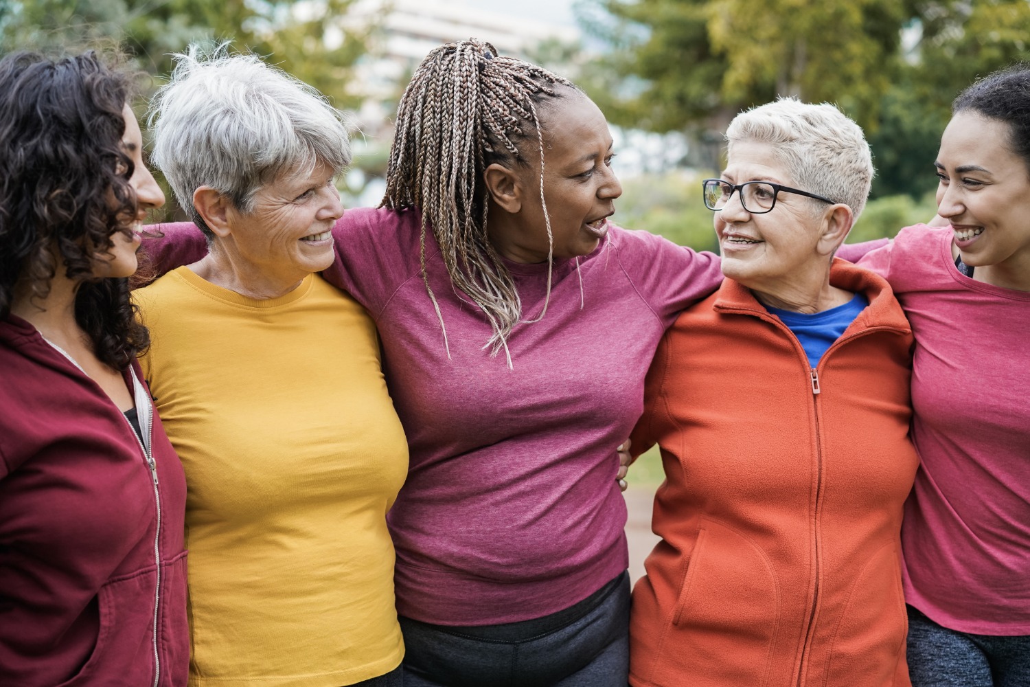 A group of ladies in a hugging formation