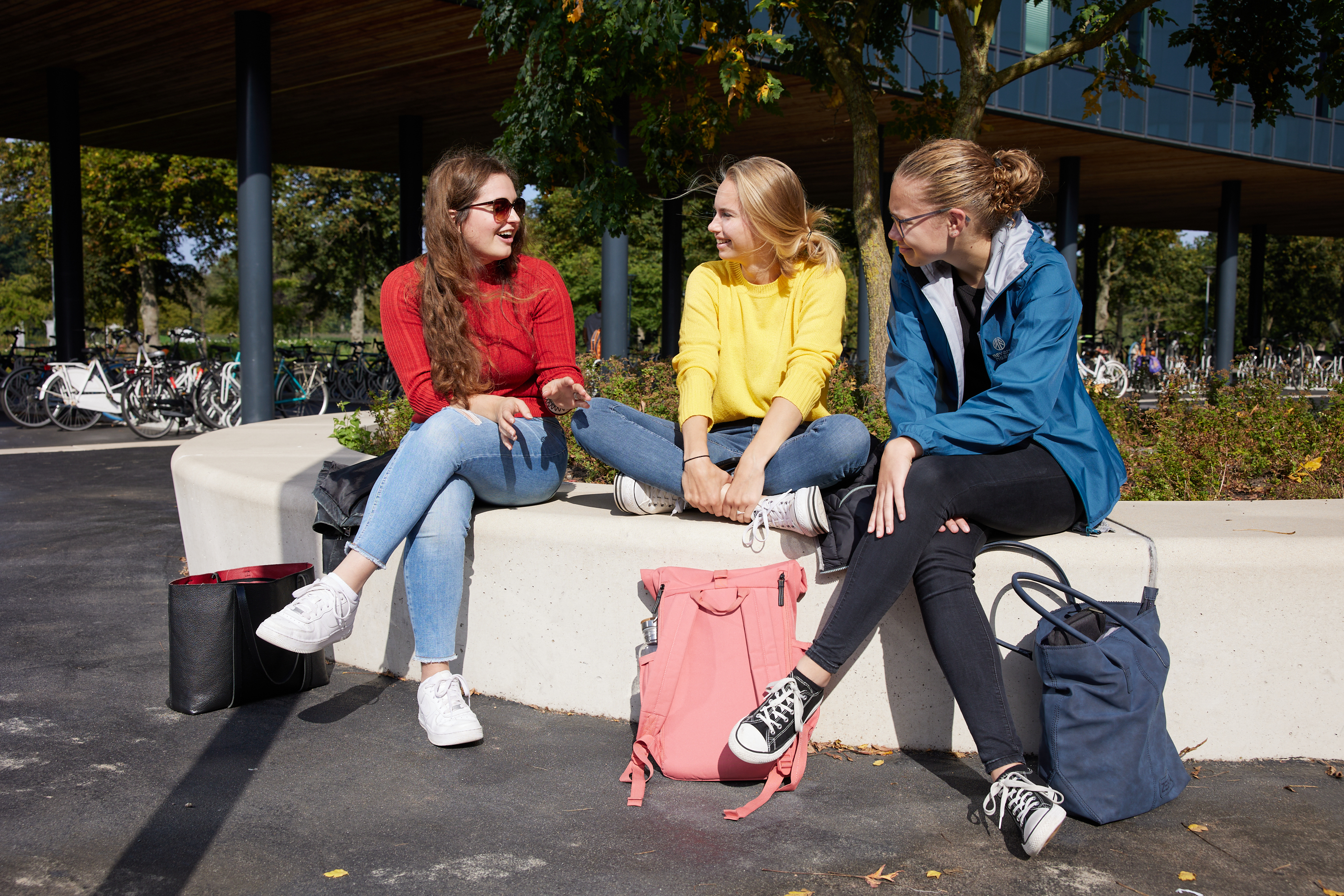 Groepje studenten zit buiten bij elkaar