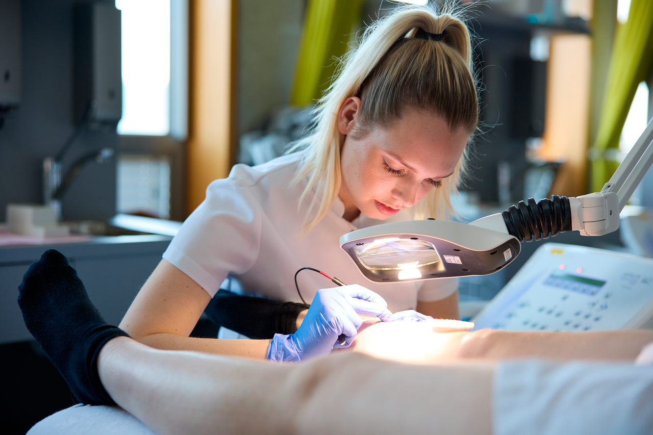 Huidtherapie studente voert behandeling uit bij patient