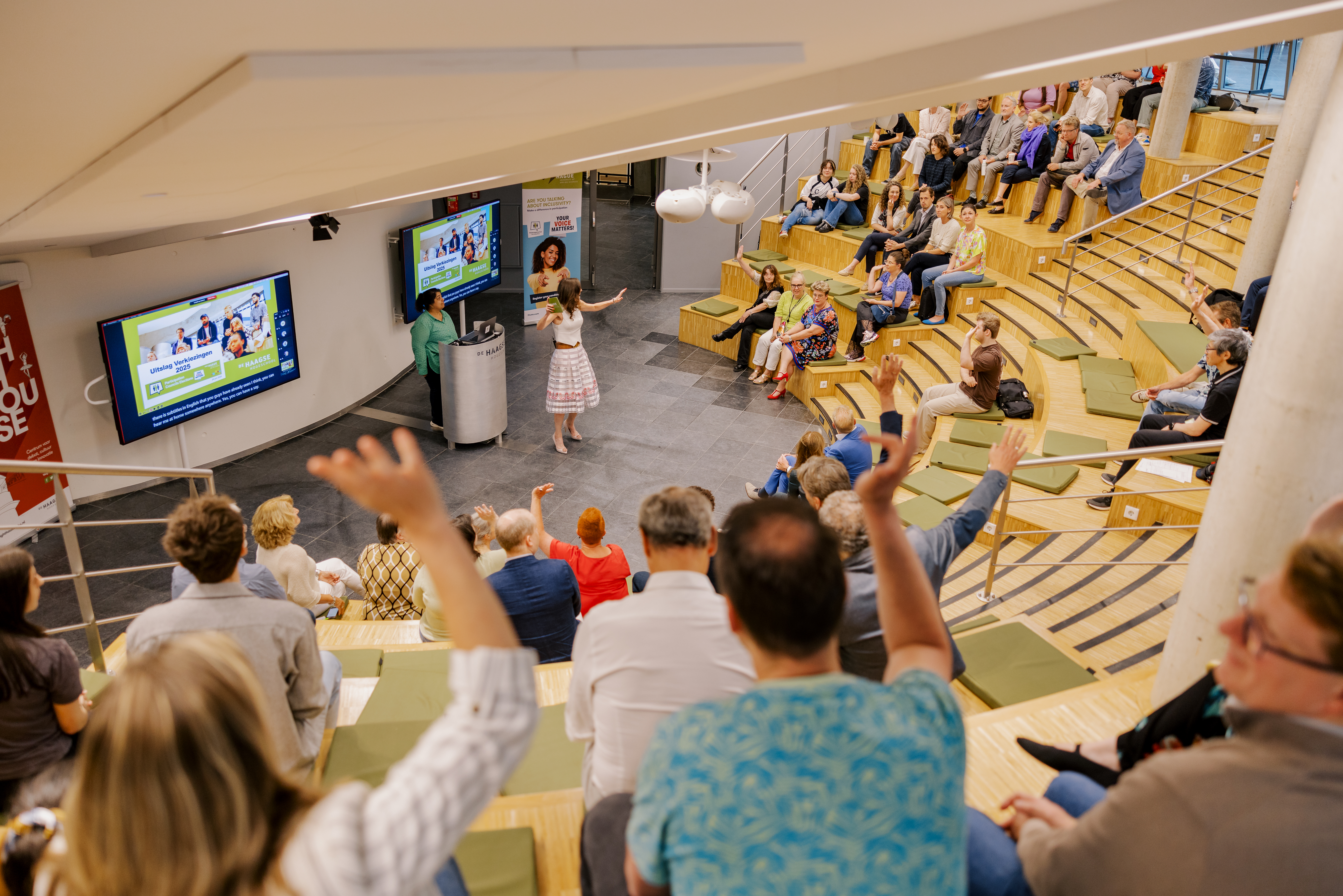 Groep studenten en docenten in een zaal